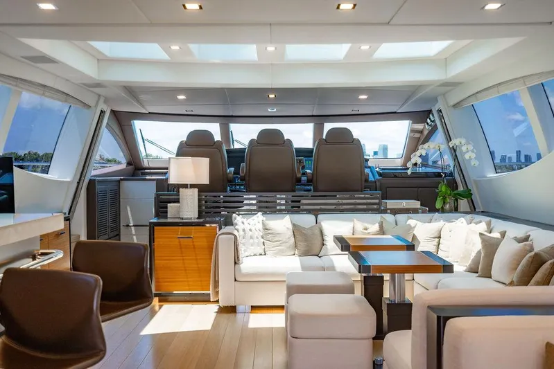 Mixed Emotions Yacht Photos Pics Luxurious interior of 2014 Mangusta 110 yacht with modern seating and panoramic windows.