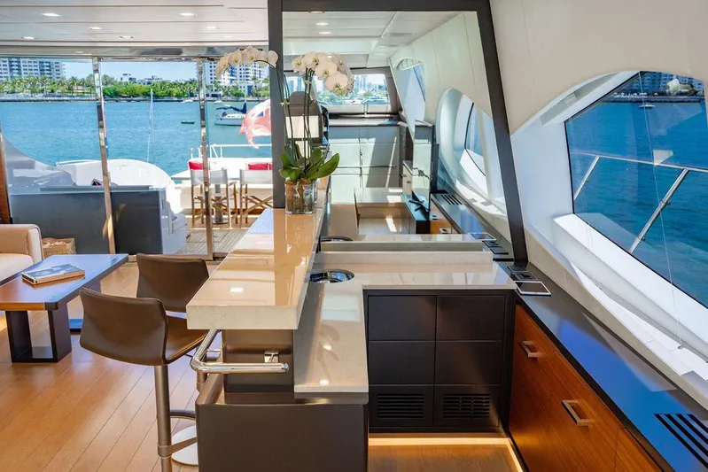 Mixed Emotions Yacht Photos Pics Luxurious interior of 2014 Mangusta 110 yacht with modern kitchen and ocean view.