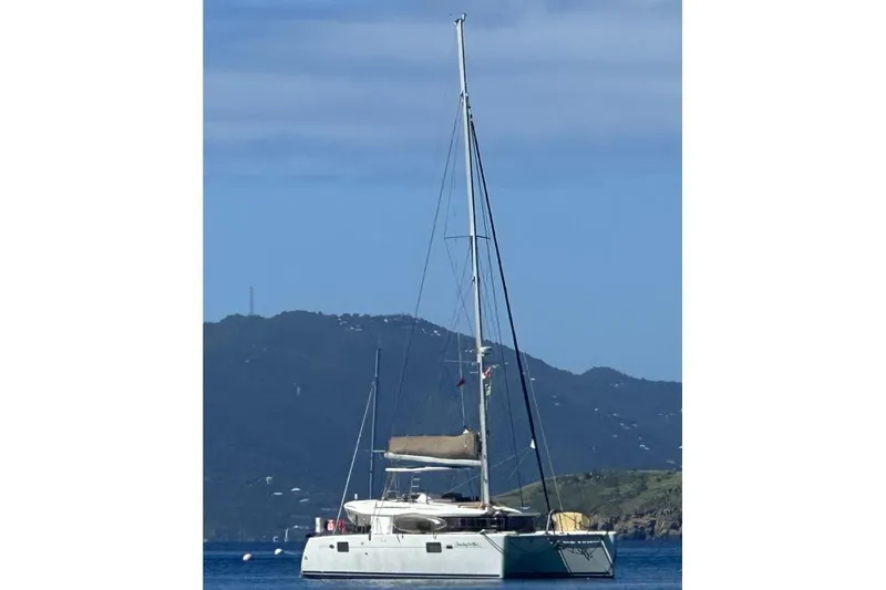 Searching For Bliss Yacht Photos Pics 2011 Lagoon 450 F catamaran sailing on calm waters with mountainous backdrop.