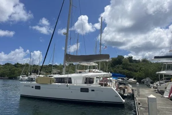 Searching For Bliss Yacht Photos Pics 2011 Lagoon 450 F catamaran docked at marina under partly cloudy sky.