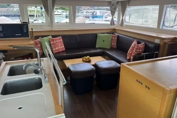 Searching For Bliss Yacht Photos Pics Interior of 2011 Lagoon 450 F catamaran with cozy seating and kitchen area.