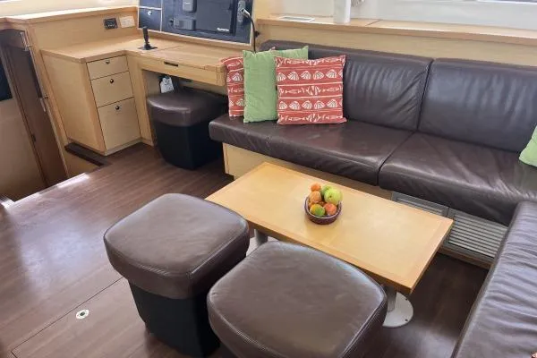 Searching For Bliss Yacht Photos Pics Interior of 2011 Lagoon 450 F yacht with leather seating and fruit bowl on table.