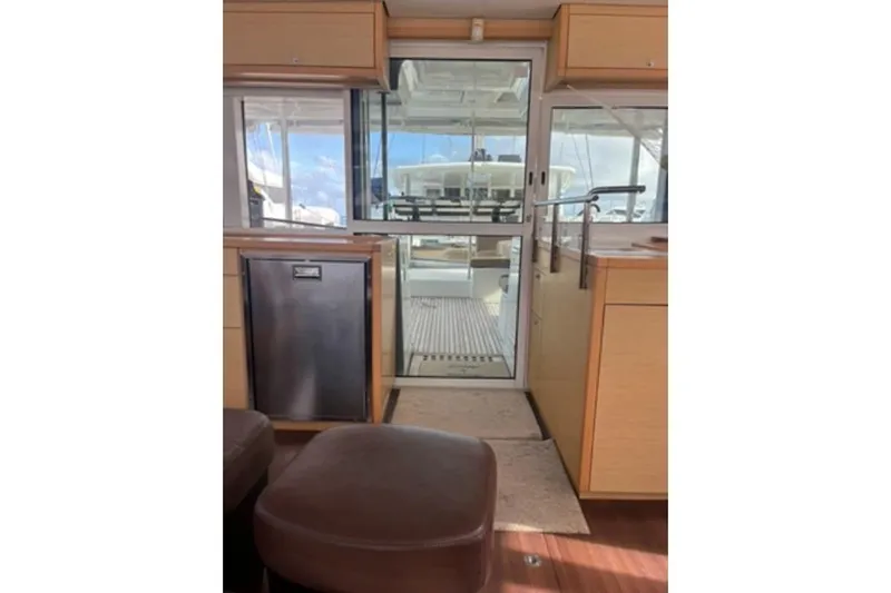 Searching For Bliss Yacht Photos Pics Interior view of 2011 Lagoon 450 F catamaran, featuring modern kitchen and outdoor access.