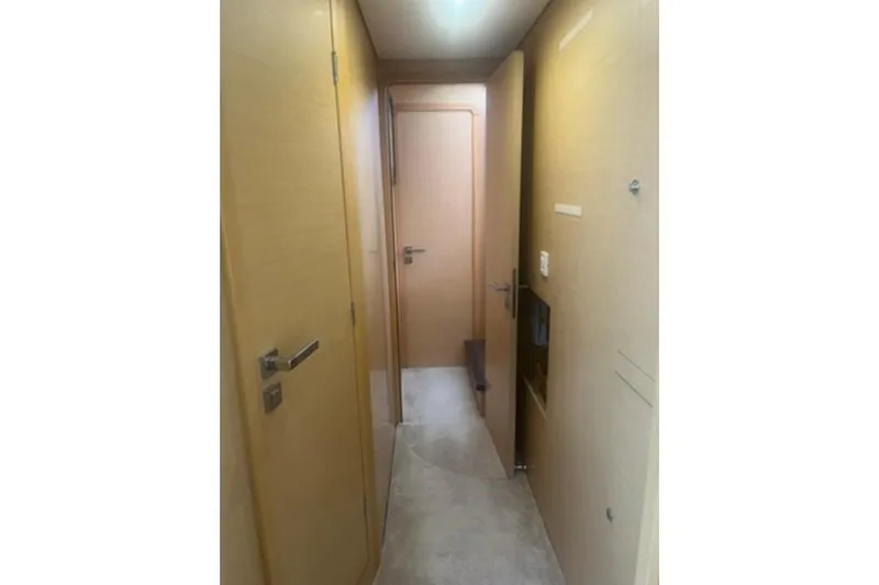 Searching For Bliss Yacht Photos Pics Interior hallway of 2011 Lagoon 450 F yacht, featuring light wood paneling.