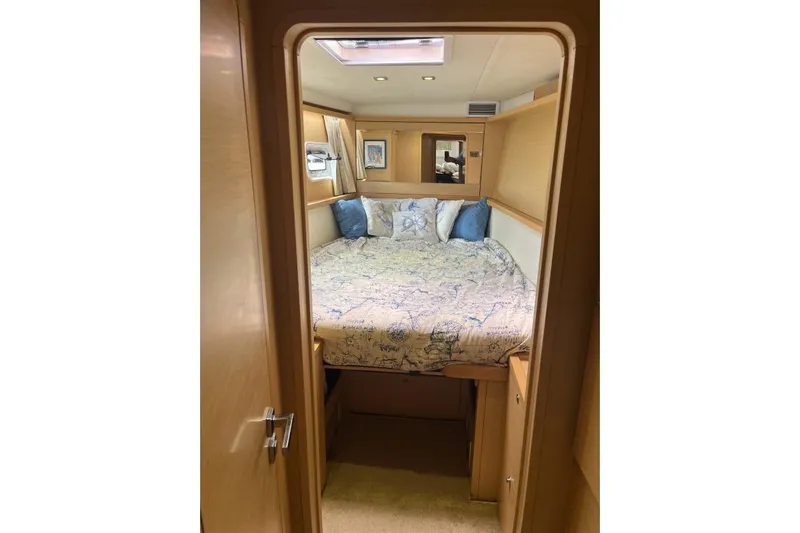 Searching For Bliss Yacht Photos Pics Cozy bedroom interior of 2011 Lagoon 450 F yacht with nautical-themed bedding.