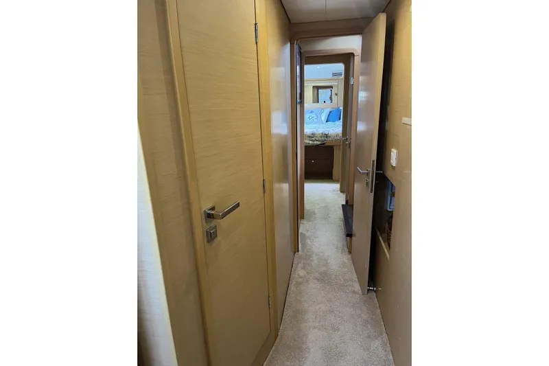 Searching For Bliss Yacht Photos Pics Interior hallway of 2011 Lagoon 450 F yacht, featuring wooden doors and carpeted flooring.