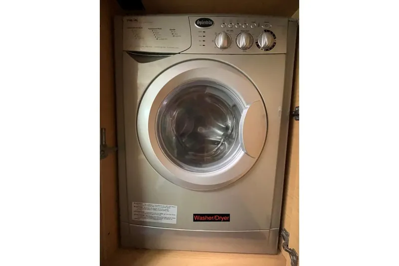 Searching For Bliss Yacht Photos Pics Compact washer/dryer unit in a Lagoon 450 F, 2011 model yacht interior.