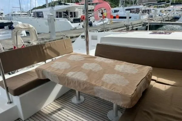 Searching For Bliss Yacht Photos Pics Outdoor seating area on a 2011 Lagoon 450 F yacht at a marina.