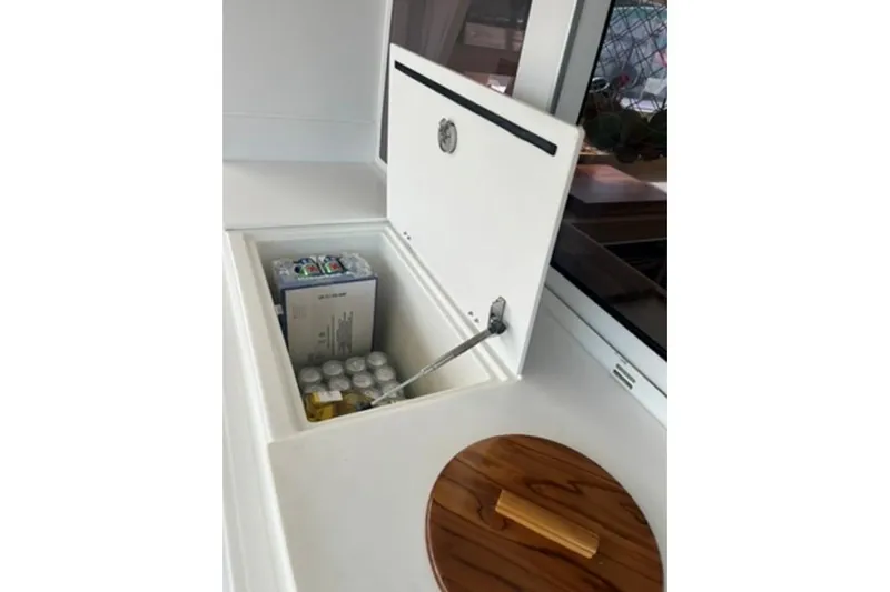 Searching For Bliss Yacht Photos Pics Open storage compartment on 2011 Lagoon 450 F yacht, containing beverages and supplies.