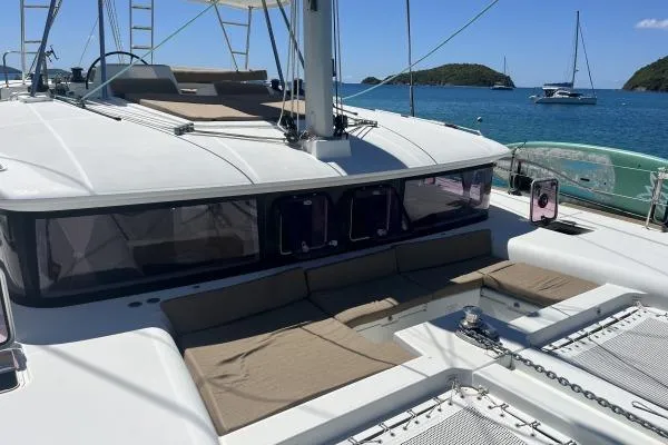 Searching For Bliss Yacht Photos Pics 2011 Lagoon 450 F catamaran on serene blue waters with island backdrop.