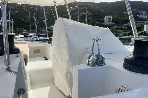 Searching For Bliss Yacht Photos Pics 2011 Lagoon 450 F yacht deck with covered equipment, marina background.