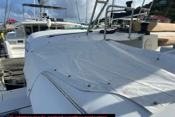 Searching For Bliss Yacht Photos Pics Lagoon 450 F 2011 yacht with custom cockpit weather protector in marina setting.