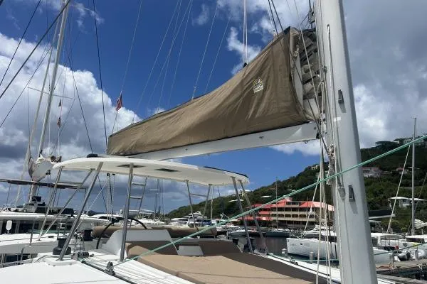 Searching For Bliss Yacht Photos Pics 2011 Lagoon 450 F catamaran docked at marina under blue sky.