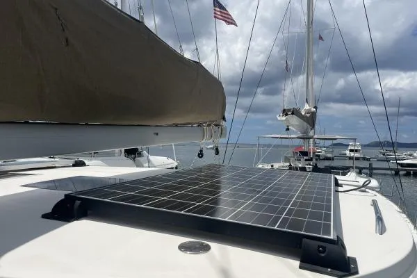 Searching For Bliss Yacht Photos Pics 2011 Lagoon 450 F catamaran with solar panel, docked under cloudy sky.