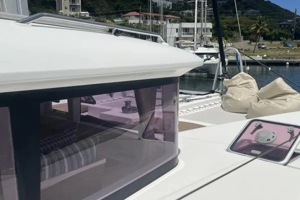 Searching For Bliss Yacht Photos Pics Lagoon 450 F catamaran, 2011 model, docked in a marina with scenic background.