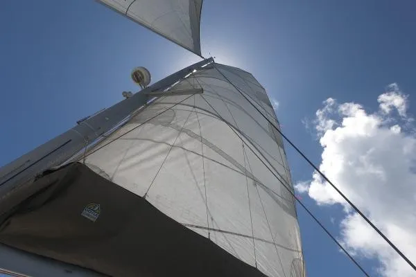 Searching For Bliss Yacht Photos Pics Sails of a 2011 Lagoon 450 F catamaran against a clear blue sky.
