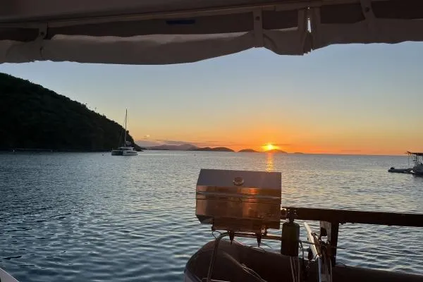 Searching For Bliss Yacht Photos Pics Sunset view from Lagoon 450 F yacht, 2011 model, with calm sea and distant islands.