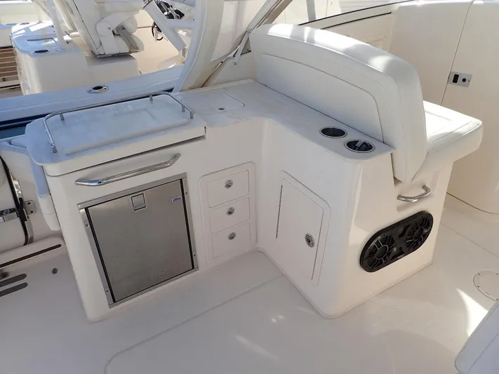  Yacht Photos Pics 2019 Grady-White Freedom 325 boat interior with seating, storage, and cup holders.