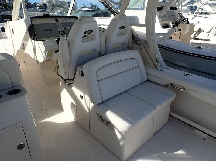  Yacht Photos Pics 2019 Grady-White Freedom 325 boat interior with white seating and modern dashboard.