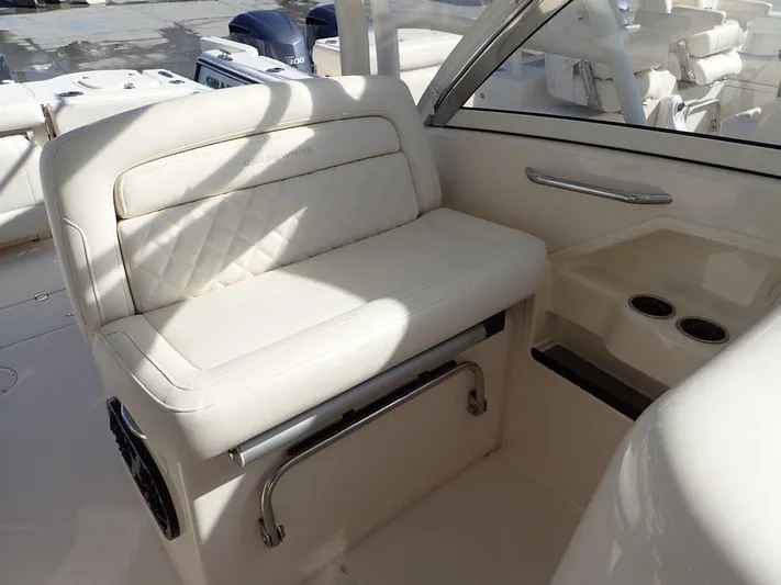  Yacht Photos Pics 2019 Grady-White Freedom 325 boat interior with white cushioned seating and cup holders.
