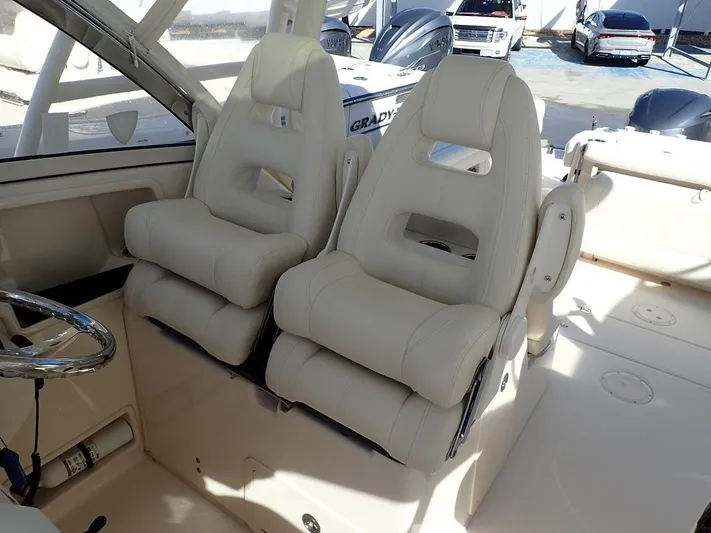  Yacht Photos Pics 2019 Grady-White Freedom 325 boat interior with plush seating and steering wheel.