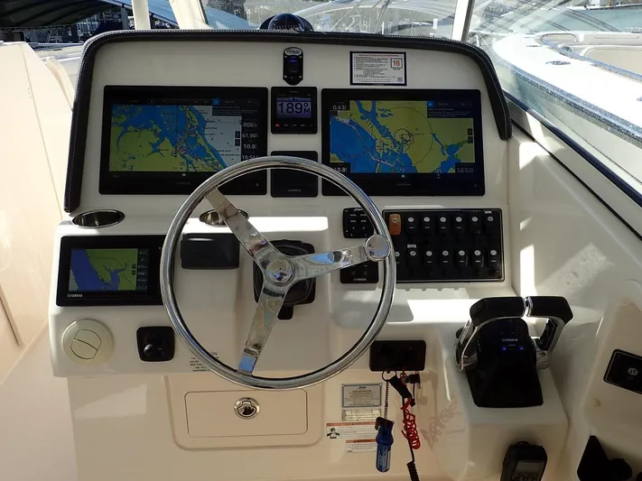  Yacht Photos Pics 2019 Grady-White Freedom 325 boat dashboard with navigation screens and steering wheel.