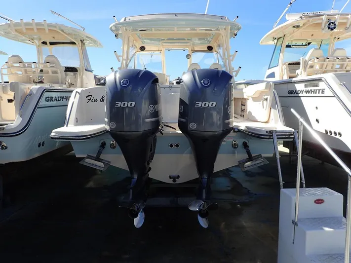  Yacht Photos Pics 2019 Grady-White Freedom 325 boat with twin Yamaha 300 engines, docked alongside similar models.