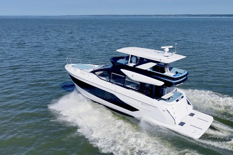  Yacht Photos Pics 2026 Cruisers Yachts 57 Fly cruising on open water, showcasing sleek design and luxury.