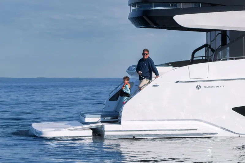  Yacht Photos Pics 2026 Cruisers Yachts 57 Fly on calm water with passengers enjoying the view.