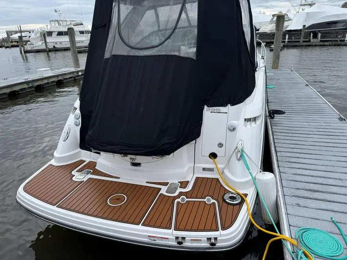  Yacht Photos Pics 2020 Monterey 295 Sport Yacht docked, featuring a sleek design and wooden deck.