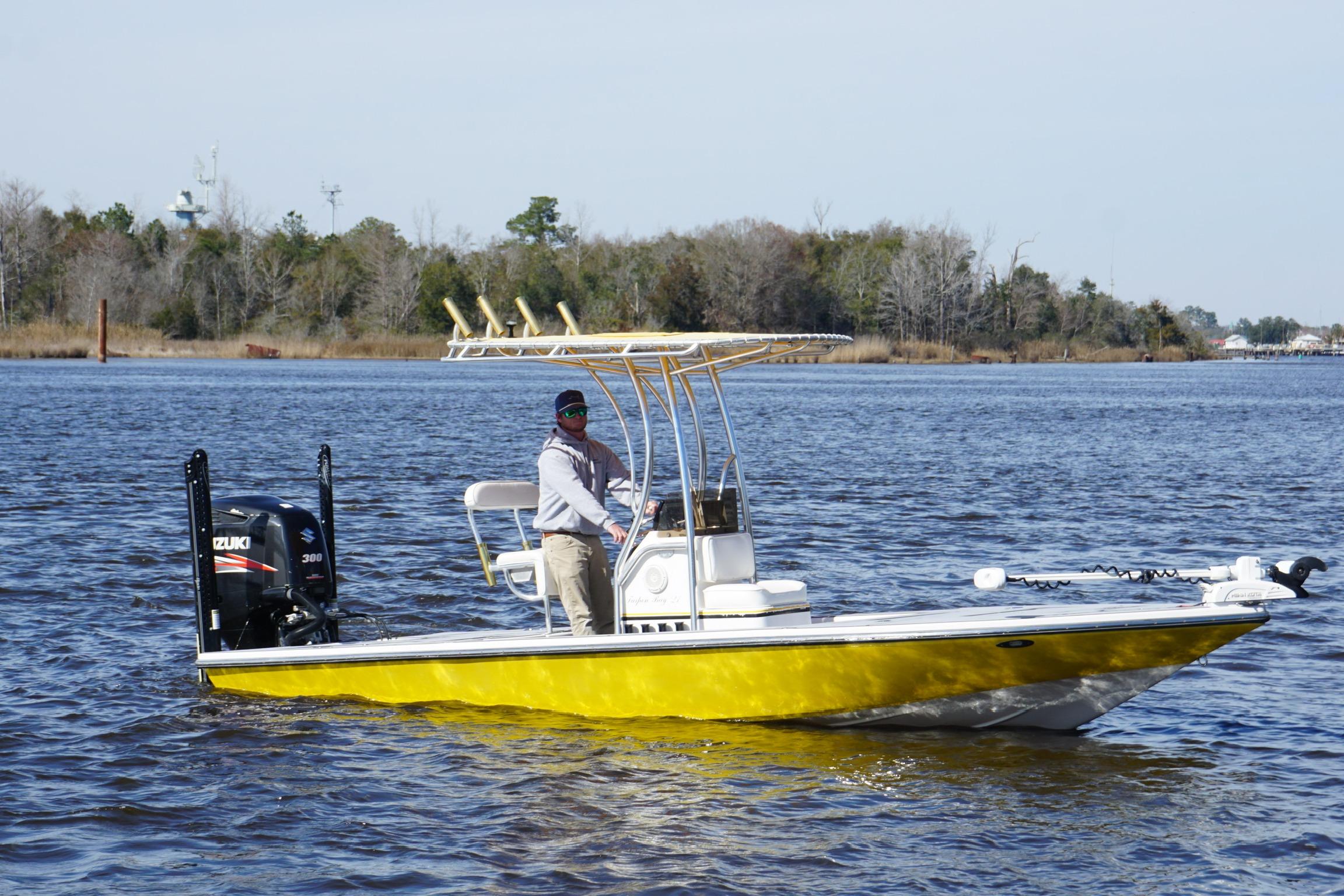 2008 Release Tarpon Bay boat with Suzuki engine on a calm river.
