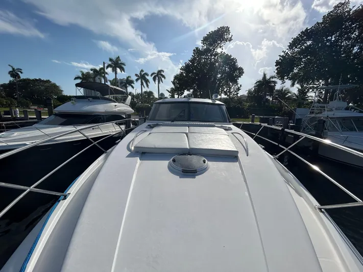  Yacht Photos Pics Front view of a 2006 Neptunus 55 Cabrio yacht docked under a sunny sky.