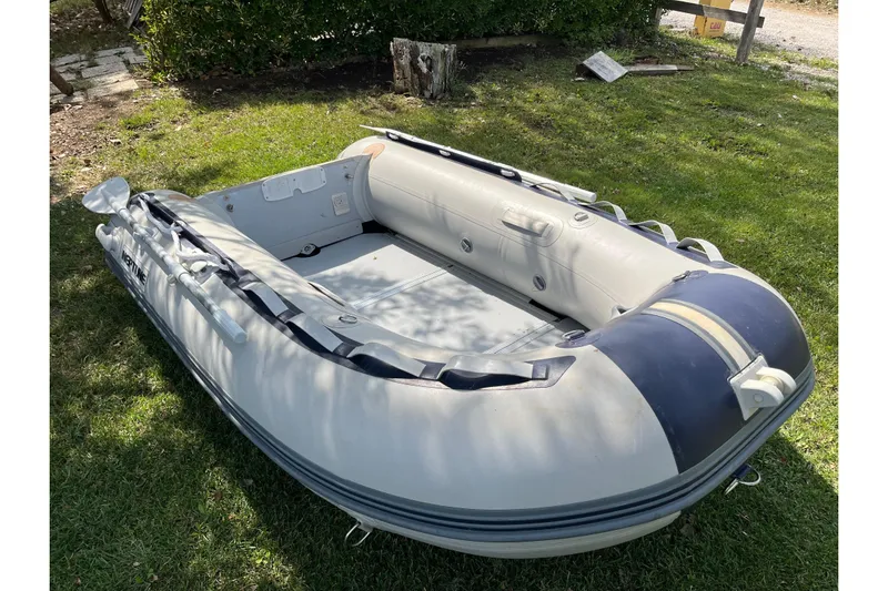 Arma Di Re Yacht Photos Pics Inflatable dinghy on grass, associated with 1983 Hallberg-Rassy 42E sailboat.