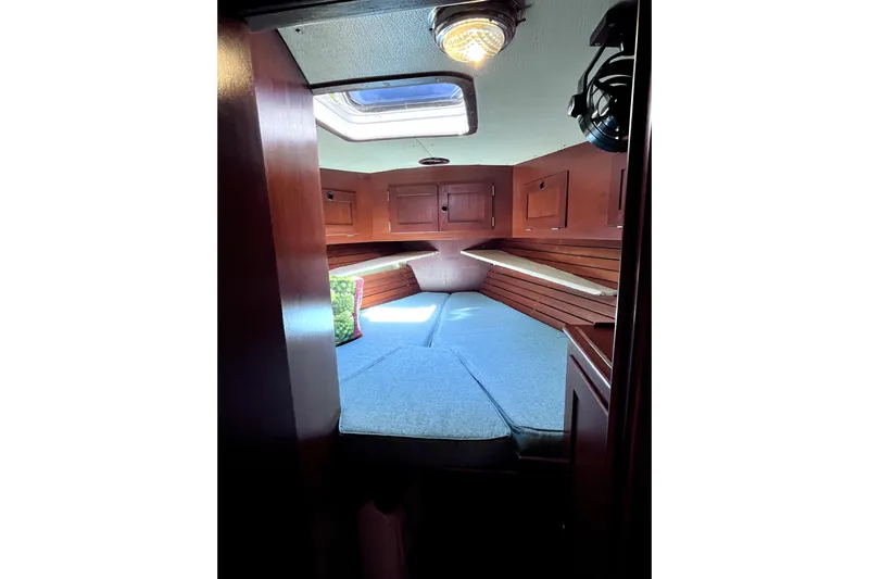 Arma Di Re Yacht Photos Pics Cozy cabin interior of 1983 Hallberg-Rassy 42E sailboat with wooden finish and skylight.