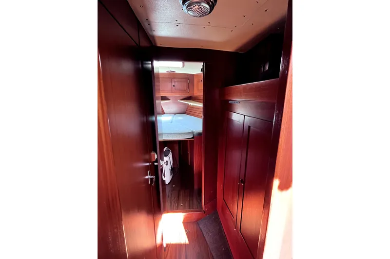 Arma Di Re Yacht Photos Pics Interior of 1983 Hallberg-Rassy 42E sailboat with wooden cabinetry and cozy sleeping area.
