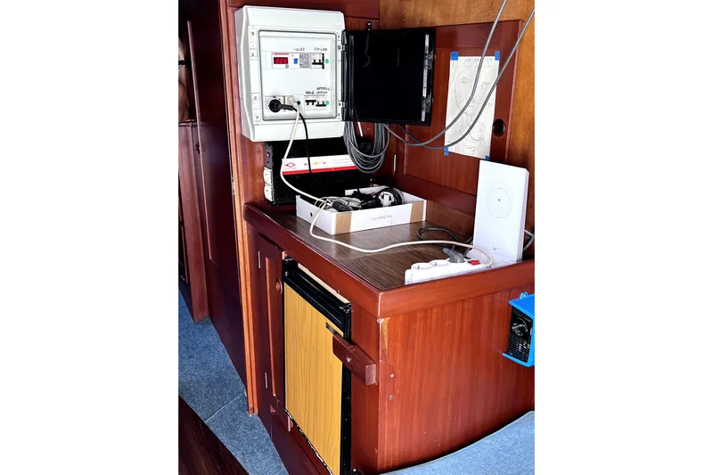 Arma Di Re Yacht Photos Pics Navigation station inside a 1983 Hallberg-Rassy 42E yacht, featuring control panel and equipment.