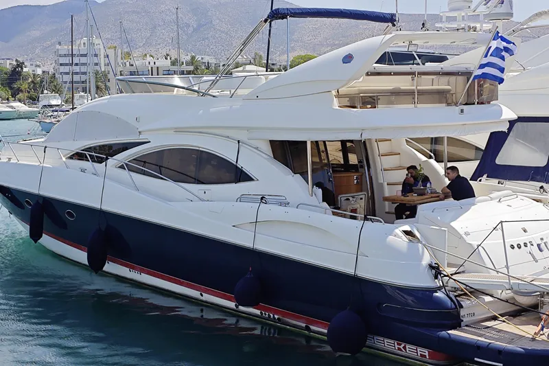  Yacht Photos Pics 2001 Sunseeker Manhattan 74 yacht docked, featuring sleek design and spacious deck area.