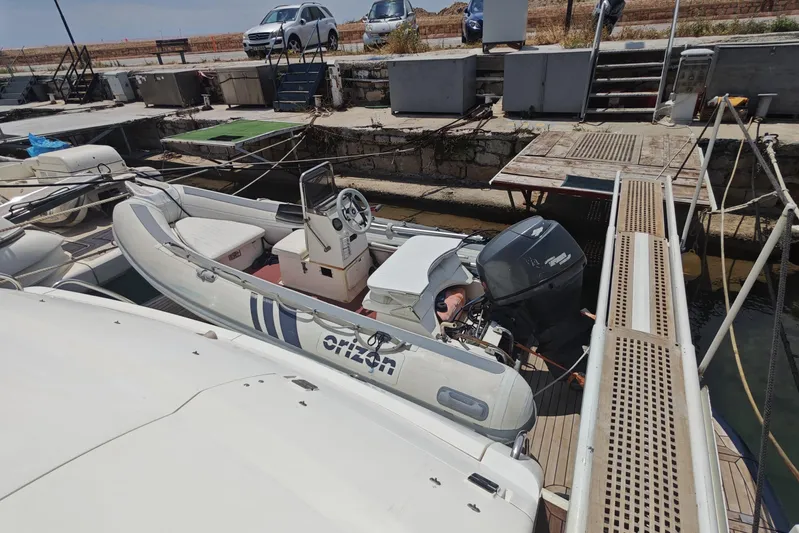  Yacht Photos Pics 2001 Sunseeker Manhattan 74 yacht docked with inflatable boat and outboard motor.