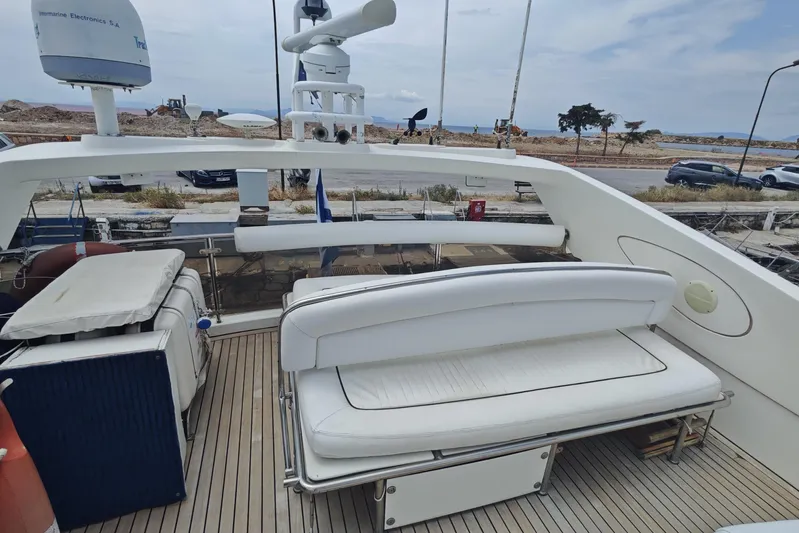  Yacht Photos Pics Sunseeker Manhattan 74 yacht deck with seating, 2001 model, docked near shoreline.