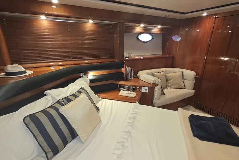  Yacht Photos Pics Luxurious cabin interior of 2001 Sunseeker Manhattan 74 yacht with elegant wood finishes.