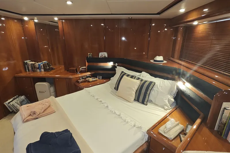  Yacht Photos Pics Luxurious cabin interior of 2001 Sunseeker Manhattan 74 yacht with elegant wood finish.