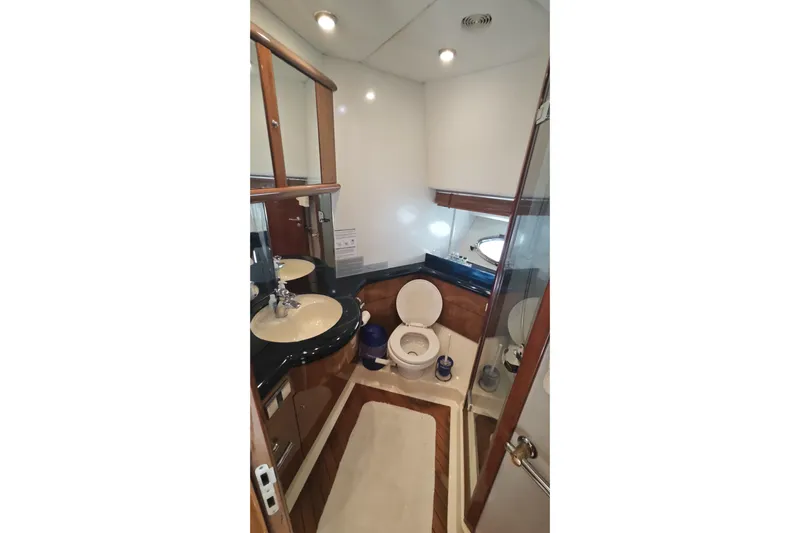  Yacht Photos Pics Luxurious bathroom in 2001 Sunseeker Manhattan 74 yacht with modern fixtures and elegant design.
