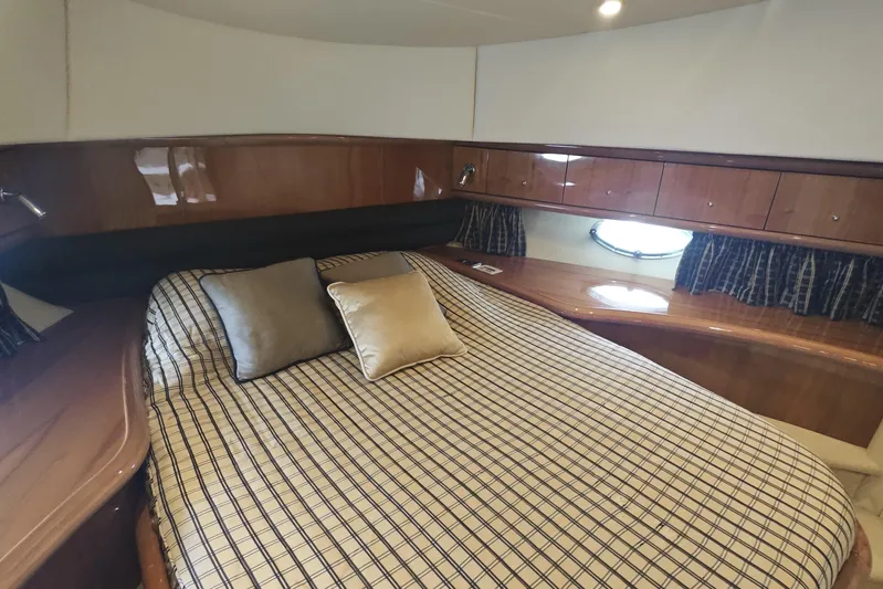  Yacht Photos Pics Luxurious cabin interior of 2001 Sunseeker Manhattan 74 yacht with elegant wood finish.