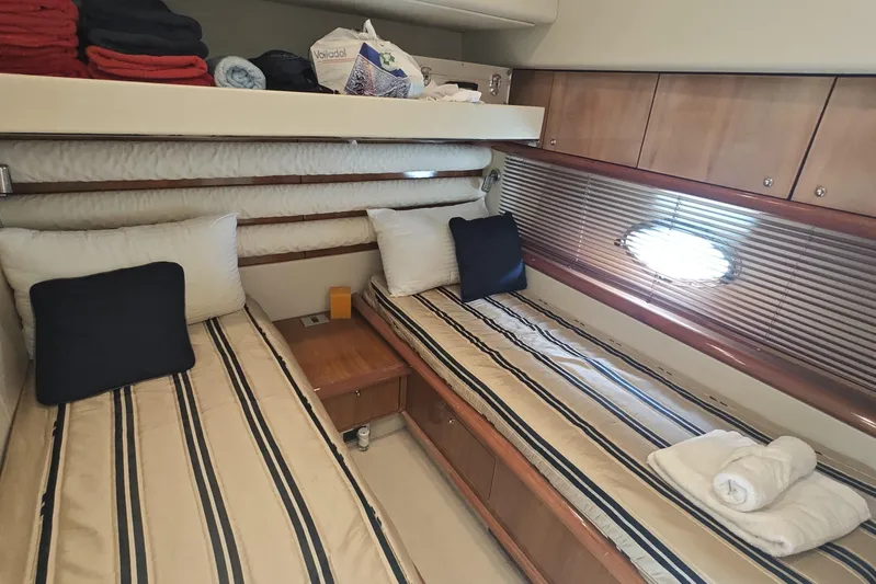  Yacht Photos Pics Luxurious cabin interior of 2001 Sunseeker Manhattan 74 yacht with twin beds and elegant decor.