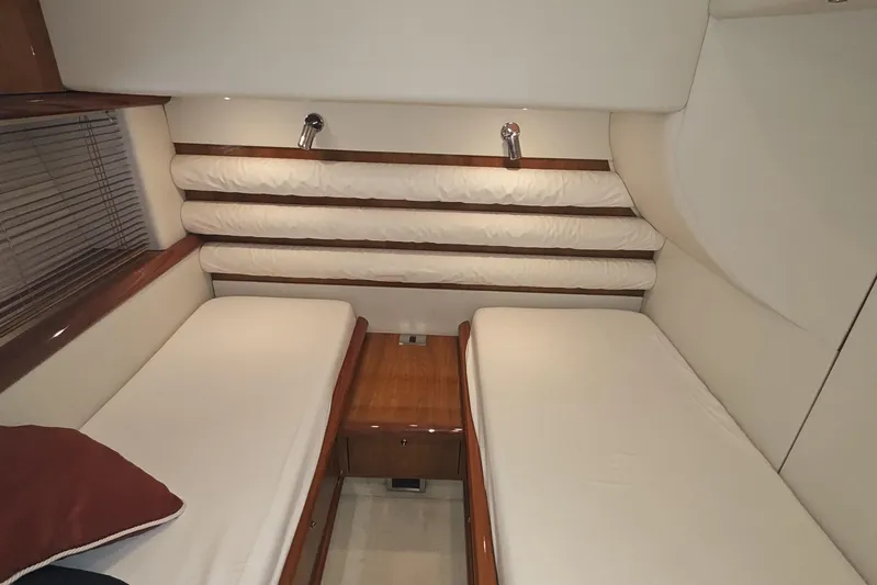  Yacht Photos Pics Interior cabin of 2001 Sunseeker Manhattan 74 yacht with twin beds and wooden accents.