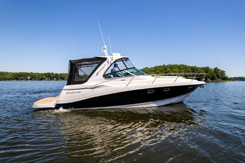 Four Fans Yacht Photos Pics 2008 Four Winns V378 boat cruising on a lake under clear blue skies.
