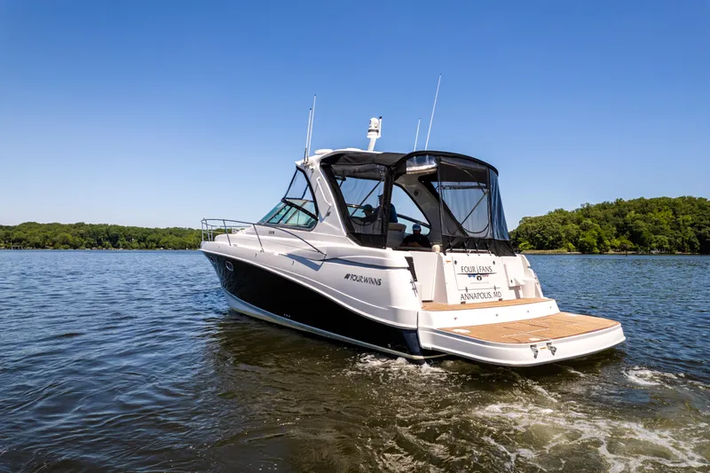 Four Fans Yacht Photos Pics 2008 Four Winns V378 boat cruising on a lake under clear blue skies.