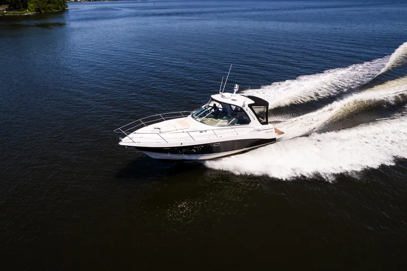 Four Fans Yacht Photos Pics 2008 Four Winns V378 yacht cruising on open water, creating a wake.