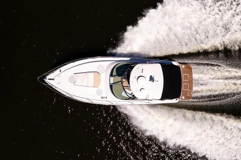 Four Fans Yacht Photos Pics Aerial view of 2008 Four Winns V378 yacht cruising on water.