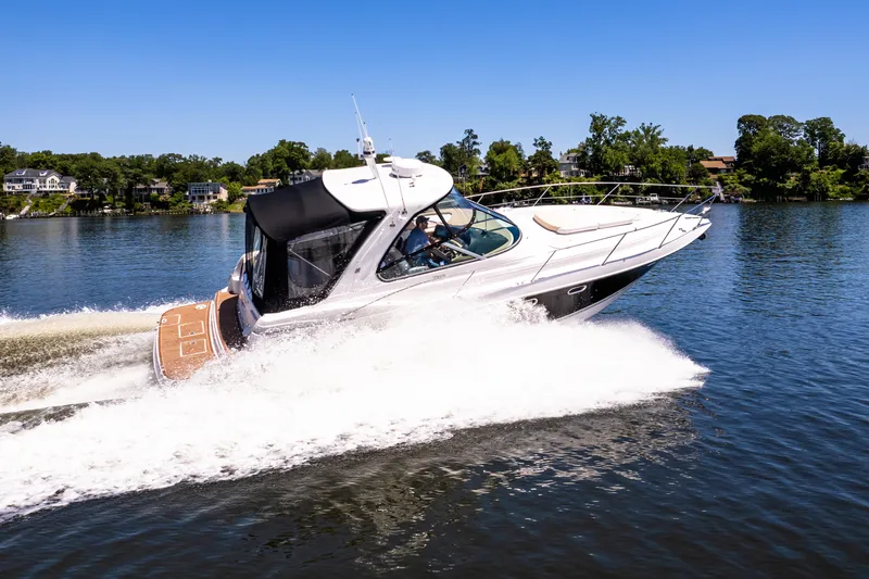 Four Fans Yacht Photos Pics 2008 Four Winns V378 boat cruising on a lake under clear blue skies.